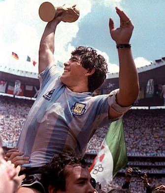 FILES, MEXICO - JUNE 29:  Diego Maradona raises the World Cup trophy after Argentina won the 1986 Mexico City World Cup in this June 1986 file photo.  Argentina's football federation (AFA) announced 26 September 2001 that it has decided to retire the number 10 shirt in honor of Maradona's contribution to the game.  Maradona, who played for Argentina between 1977 and 1994, will wear the number for the last time on 10 November in a match in his honour against a world all-star team.  AFP PHOTO  (Photo credit should read STAFF/AFP/Getty Images)