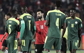 25 March 2022, Egypt, Cairo: Egypt's Mohamed Salah shakes hands with Senegal players after the final whistle of the 2022 FIFA World Cup qualification (CAF) third round 1st leg soccer match between Egypt and Senegal at Cairo Stadium. Photo: Omar Zoheiry/dpa (Photo by Omar Zoheiry/picture alliance via Getty Images)