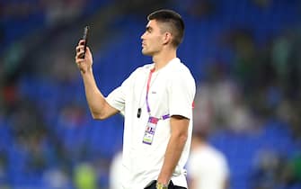DOHA, QATAR - NOVEMBER 22: Johan Vasquez of Mexico holds up his mobile phone as he inspects the pitch prior to the FIFA World Cup Qatar 2022 Group C match between Mexico and Poland at Stadium 974 on November 22, 2022 in Doha, Qatar. (Photo by David Ramos - FIFA/FIFA via Getty Images)