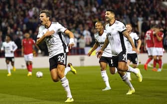Fulham's Joao Palhinha (left) celebrates scoring their side's second goal of the game with team-mates during the Premier League match at The City Ground, Nottingham. Picture date: Friday September 16, 2022.