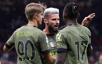 AC Milan’s Rafael Leao (R) jubilates with his teammates  Charles De Ketelaere (L)  and  Olivier Giroud   jubilates after scoring goal of 1 to 0 during the Italian serie A soccer match between AC Milan and Bologna  at Giuseppe Meazza stadium in Milan, 27 August 2022.ANSA / MATTEO BAZZI