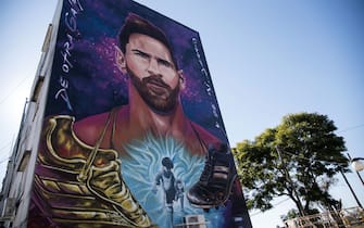 View of a giant mural depicting Argentinian football star Lionel Messi upon its unveiling in Rosario, Santa Fe, Argentina. - The mural, located in front of the school which Messi attended as a child, is the work of Argentinian artists Fer Lerena, Massi Ledesma, Lisandro Urteaga and Marlen Zuriaga. - RESTRICTED TO EDITORIAL USE - MANDATORY MENTION OF THE ARTIST UPON PUBLICATION - TO ILLUSTRATE THE EVENT AS SPECIFIED IN THE CAPTION (Photo by Marcelo Manera / AFP) / RESTRICTED TO EDITORIAL USE - MANDATORY MENTION OF THE ARTIST UPON PUBLICATION - TO ILLUSTRATE THE EVENT AS SPECIFIED IN THE CAPTION / RESTRICTED TO EDITORIAL USE - MANDATORY MENTION OF THE ARTIST UPON PUBLICATION - TO ILLUSTRATE THE EVENT AS SPECIFIED IN THE CAPTION (Photo by MARCELO MANERA/AFP via Getty Images)