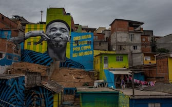 SAO PAULO, BRAZIL - JUNE 12: Children play soccer in front of the graffiti mural of the striker of the Brazilian soccer team Gabriel Jesus on June 12, 2018 in Sao Paulo, Brazil.  The painting was done by a group of artists to pay homage to the attacker who grew up in the area, the Jardim Peri neighborhood that is one of the poorest neighborhoods in the city of SÃƒÂ£o Paulo. (Photo by Victor Moriyama/Getty Images)