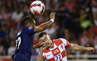France's midfielder Christopher Nkunku (L) fights for the ball with Croatia's defender Josip Juranovic during the UEFA Nations League - League A Group 1 football match between Croatia and France at Stadion Poljud in Split, on June 6, 2022. (Photo by FRANCK FIFE / AFP) (Photo by FRANCK FIFE/AFP via Getty Images)