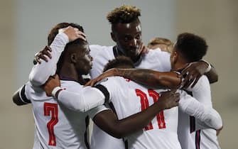epa09515581 England's Buyako Saka (L), accompanied by teammates, reacts after scoring the second goal against Andorra during the FIFA World Cup 2022 qualifying soccer match between Andorra and England in Andorra la Vella, Andorra, 09 October 2021.  EPA/ALEJANDRO GARCIA