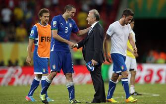 RECIFE, BRAZIL - JUNE 19:  Giorgio Chiellini of Italy  consoles Alberto Zaccheroni head coach of Japan at the end of the FIFA Confederations Cup Brazil 2013 Group A match between Italy and Japan at Arena Pernambuco on June 19, 2013 in Recife, Brazil.  (Photo by Friedemann Vogel - FIFA/FIFA via Getty Images)