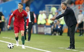 epa06840017 Cristiano Ronaldo of Portugal (L) and  Iran's coach Carlos Queiroz in action during the FIFA World Cup 2018 group B preliminary round soccer match between Iran and Portugal in Saransk, Russia, 25 June 2018.(RESTRICTIONS APPLY: Editorial Use Only, not used in association with any commercial entity - Images must not be used in any form of alert service or push service of any kind including via mobile alert services, downloads to mobile devices or MMS messaging - Images must appear as still images and must not emulate match action video footage - No alteration is made to, and no text or image is superimposed over, any published image which: (a) intentionally obscures or removes a sponsor identification image; or (b) adds or overlays the commercial identification of any third party which is not officially associated with the FIFA World Cup)  EPA/RUNGROJ YONGRIT   EDITORIAL USE ONLY
