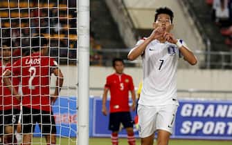 epa05030114 Son Heung-min of South Korea celebrates after scoring his team's third goal during the first half of an Asian second-round Group G match against Laos in the 2018 World Cup qualifiers at New Laos National Stadium in Vientiane, Laos, on Nov. 17, 2015. South Korea won the match 5-0.  EPA/STR