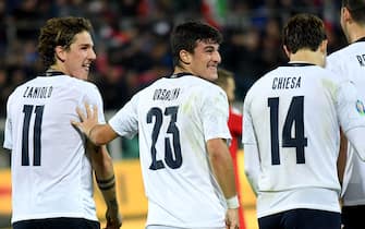 Italy's forward Riccardo Orsolini (C) celebrates with Italy's midfielder Nicolo Zaniolo (L) after scoring during the Euro 2020 1st round Group J qualifying football match Italy v Armenia on November 18, 2019 at the Renzo-Barbera stadium in Palermo. (Photo by Andreas SOLARO / AFP) (Photo by ANDREAS SOLARO/AFP via Getty Images)