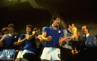 11 Jul 1982:  Dino Zoff (third right) of Italy is presented with the trophy by King Juan Carlos (right) of Spain as the rest of the Italian team celebrate after the World Cup Final match against West Germany at the Bernabeu Stadium in Madrid, Spain. Italy won the match 3-1 \ Mandatory Credit: Steve  Powell/Allsport