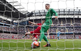 Manchester City goalkeeper Ederson calmly clears the ball from his goal line under pressure from Liverpool's Diogo Jota, during the Premier League match at the Etihad Stadium, Manchester. Picture date: Sunday April 10, 2022. (Photo by Martin Rickett/PA Images via Getty Images)