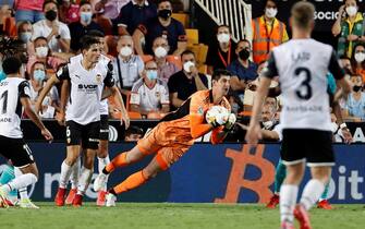 epa09477305 Real Madrid's goalkeeper Thibaut Courtois (C) in action during the Spanish La Liga soccer match between Valencia CF and Real Madrid at Mestalla stadium in Valencia, eastern Spain, 19 September 2021.  EPA/Kai Foersterling
