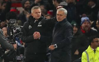 1186503840 MANCHESTER, ENGLAND - DECEMBER 04: Ole Gunnar Solskjaer the head coach / maanager of Manchester United consoles Jose Mourino the head coach / manager of Tottenham Hotspur walks off after the Premier League match between Manchester United and Tottenham Hotspur at Old Trafford on December 4, 2019 in Manchester, United Kingdom. (Photo by Matthew Ashton - AMA/Getty Images)