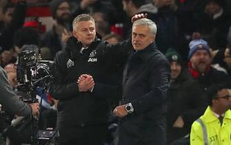 MANCHESTER, ENGLAND - DECEMBER 04: Ole Gunnar Solskjaer the head coach / maanager of Manchester United consoles Jose Mourino the head coach / manager of Tottenham Hotspur walks off after the Premier League match between Manchester United and Tottenham Hotspur at Old Trafford on December 4, 2019 in Manchester, United Kingdom. (Photo by Matthew Ashton - AMA/Getty Images)