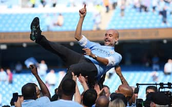 MANCHESTER, ENGLAND - MAY 06:  Josep Guardiola, Manager of Manchester City is thrown into the air as he and his team celebrate winning the premier league after the Premier League match between Manchester City and Huddersfield Town at Etihad Stadium on May 6, 2018 in Manchester, England.  (Photo by Shaun Botterill/Getty Images)