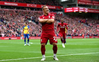 LIVERPOOL, ENGLAND - SEPTEMBER 22:  Xherdan Shaqiri of Liverpool celebrates after he provides the assist for Liverpool's first goal, an own goal by Wesley Hoedt of Southampton during the Premier League match between Liverpool FC and Southampton FC at Anfield on September 22, 2018 in Liverpool, United Kingdom.  (Photo by Alex Livesey/Getty Images)