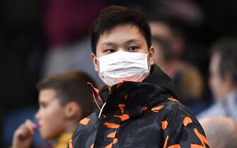 BURNLEY, ENGLAND - MARCH 07: A fan wears a protective mask during the Premier League match between Burnley FC and Tottenham Hotspur at Turf Moor on March 07, 2020 in Burnley, United Kingdom. (Photo by Stu Forster/Getty Images)