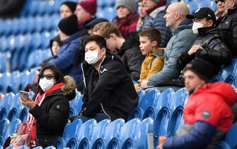 BURNLEY, ENGLAND - MARCH 07: Fans wear disposable face masks  prior to the Premier League match between Burnley FC and Tottenham Hotspur at Turf Moor on March 07, 2020 in Burnley, United Kingdom. (Photo by Michael Regan/Getty Images)