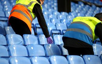 LONDON, ENGLAND - MARCH 07: Stewards clean the seats in the stands after during the Premier League match between Crystal Palace and Watford FC at Selhurst Park on March 07, 2020 in London, United Kingdom. (Photo by Christopher Lee/Getty Images)