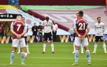 BIRMINGHAM, ENGLAND - JUNE 17: Chris Basham of Sheffield United takes part in a minute of silence commemorate the victims of the Covid-19 pandemic during the Premier League match between Aston Villa and Sheffield United at Villa Park on June 17, 2020 in Birmingham, England. (Photo by Paul Ellis/Pool via Getty Images)
