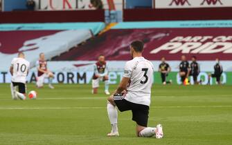 Sheffield United's Irish defender Enda Stevens kneels  during a minute of silence prior to the  English Premier League football match between Aston Villa and Sheffield United at Villa Park in Birmingham, central England on June 17, 2020. - The Premier League makes its eagerly anticipated return today after 100 days in lockdown but behind closed doors due to coronavirus restrictions. (Photo by CARL RECINE / various sources / AFP) / RESTRICTED TO EDITORIAL USE. No use with unauthorized audio, video, data, fixture lists, club/league logos or 'live' services. Online in-match use limited to 120 images. An additional 40 images may be used in extra time. No video emulation. Social media in-match use limited to 120 images. An additional 40 images may be used in extra time. No use in betting publications, games or single club/league/player publications. /  (Photo by CARL RECINE/AFP via Getty Images)