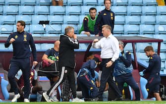 Sheffield United's English manager Chris Wilder (L) and Aston Villa's English head coach Dean Smith (R) go to bump arms at the final whistle during the English Premier League football match between Aston Villa and Sheffield United at Villa Park in Birmingham, central England on June 17, 2020. - The Premier League makes its eagerly anticipated return today after 100 days in lockdown but behind closed doors due to coronavirus restrictions. (Photo by Paul ELLIS / POOL / AFP) / RESTRICTED TO EDITORIAL USE. No use with unauthorized audio, video, data, fixture lists, club/league logos or 'live' services. Online in-match use limited to 120 images. An additional 40 images may be used in extra time. No video emulation. Social media in-match use limited to 120 images. An additional 40 images may be used in extra time. No use in betting publications, games or single club/league/player publications. /  (Photo by PAUL ELLIS/POOL/AFP via Getty Images)