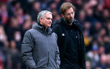 MANCHESTER, ENGLAND - MARCH 10:  Jose Mourinho, Manager of Manchester United and Jurgen Klopp, Manager of Liverpool speak during the Premier League match between Manchester United and Liverpool at Old Trafford on March 10, 2018 in Manchester, England.  (Photo by Laurence Griffiths/Getty Images)