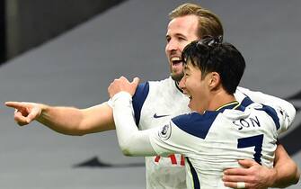 Tottenham Hotspur's English striker Harry Kane (L) celebrates scoring his team's second goal with Tottenham Hotspur's South Korean striker Son Heung-Min (R) during the English Premier League football match between Tottenham Hotspur and Arsenal at Tottenham Hotspur Stadium in London, on December 6, 2020. (Photo by Glyn KIRK / POOL / AFP) / RESTRICTED TO EDITORIAL USE. No use with unauthorized audio, video, data, fixture lists, club/league logos or 'live' services. Online in-match use limited to 120 images. An additional 40 images may be used in extra time. No video emulation. Social media in-match use limited to 120 images. An additional 40 images may be used in extra time. No use in betting publications, games or single club/league/player publications. /  (Photo by GLYN KIRK/POOL/AFP via Getty Images)