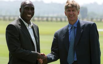 3 Jul 2001:  Sol Campbell (left) shakes hands with manager Arsene Wenger during a press conference at Arsenals training ground, London Colney, to announce his signing for Arsenal Football Club. Mandatory Credit: Jamie McDonald/ALLSPORT