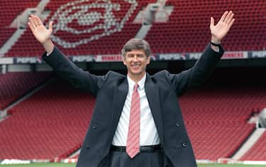 NEW ARSENAL BOSS ARSENE WENGER RAISES HIS ARMS TO CELEBRATE TAKING OVER IN THE HOT SEAT AT HIGHBURY. THE 47-YEAR-OLD REVEALED HOW HE WAS TEMPTED TO JOIN WITH HIS OLD PROTEGE GLENN HODDLE AS THE FA'S NEW TECHICAL DIRECTOR BEFORE ACCEPTING THE CHALLENGE.   (Photo by David Cheskin - PA Images/PA Images via Getty Images)