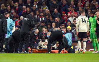 Liverpool's Naby Keita being taken off the pitch with an injury during the Premier League match at Old Trafford, Manchester. Picture date: Sunday October 24, 2021.