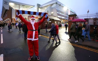 Aston Villa fan Luke Johnson arrives at the stadium dressed as Santa Claus ahead of the Premier League match at Villa Park, Birmingham. Picture date: Sunday December 26, 2021.