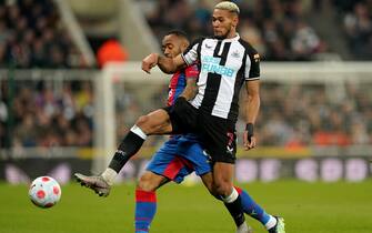 Newcastle United's Joelinton battles with Crystal Palace's Jordan Ayew during the Premier League match at St. James' Park, Newcastle upon Tyne. Picture date: Wednesday April 20, 2022.