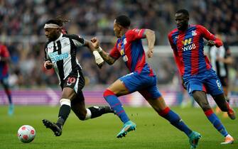 Newcastle United's Allan Saint-Maximin (left) is trailed by Crystal Palace's Nathaniel Clyne (centre) and Cheikhou Kouyate (right) during the Premier League match at St. James' Park, Newcastle upon Tyne. Picture date: Wednesday April 20, 2022.