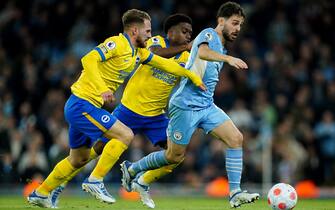 Manchester City's Bernardo Silva battles with Brighton and Hove Albion's Alexis Mac Allister (left) and Tariq Lamptey (centre) during the Premier League match at the Etihad Stadium, Manchester. Picture date: Wednesday April 20, 2022.