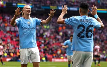 epa10586255 Riyad Mahrez (R) of Manchester City celebrates with teammate Erling Haaland (L) after scoring the 2-0 lead during the FA Cup semi final match between Manchester City vs Sheffield United in London, Britain, 22 April 2023.  EPA/TOLGA AKMEN EDITORIAL USE ONLY. No use with unauthorized audio, video, data, fixture lists, club/league logos or 'live' services. Online in-match use limited to 120 images, no video emulation. No use in betting, games or single club/league/player publications.