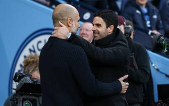 epa10593064 Manchester City manager Pep Guardiola (L) greets Arsenal manager Mikel Arteta (R) prior to the English Premier League soccer match between Manchester City and Arsenal FC in Manchester, Britain, 26 April 2023.  EPA/ADAM VAUGHAN EDITORIAL USE ONLY. No use with unauthorized audio, video, data, fixture lists, club/league logos or 'live' services. Online in-match use limited to 120 images, no video emulation. No use in betting, games or single club/league/player publications.