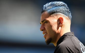 Manchester City's Brazilian goalkeeper Ederson, with blue-coloured hair, warms up ahead of the English Premier League football match between Manchester City and Chelsea at the Etihad Stadium in Manchester, north west England, on May 21, 2023. (Photo by Oli SCARFF / AFP) / RESTRICTED TO EDITORIAL USE. No use with unauthorized audio, video, data, fixture lists, club/league logos or 'live' services. Online in-match use limited to 120 images. An additional 40 images may be used in extra time. No video emulation. Social media in-match use limited to 120 images. An additional 40 images may be used in extra time. No use in betting publications, games or single club/league/player publications. /  (Photo by OLI SCARFF/AFP via Getty Images)
