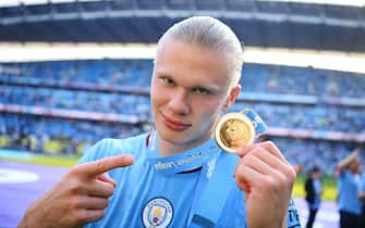 MANCHESTER, ENGLAND - MAY 21: Erling Haaland of Manchester City points to their Premier League Winners Medal following the Premier League match between Manchester City and Chelsea FC at Etihad Stadium on May 21, 2023 in Manchester, England. (Photo by Michael Regan/Getty Images)