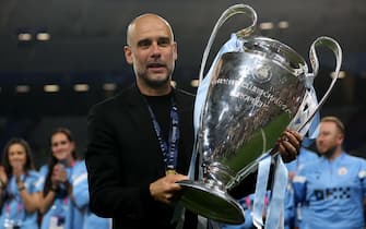 epa10684504 Manchester City manager Pep Guardiola poses with the trophy during the UEFA Champions League Final soccer match between Manchester City and Inter Milan, in Istanbul, Turkey, 10 June 2023.  EPA/MARTIN DIVISEK