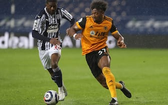West Bromwich Albion's Ainsley Maitland-Niles (left) and Wolverhampton Wanderers' Adama Traore battle for the ball during the Premier League match at The Hawthorns, West Bromwich. Issue date: Monday May 3, 2021.