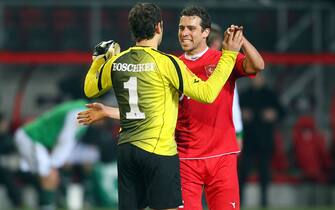 ENSCHEDE, NETHERLANDS - FEBRUARY 18: Sander Boschker of Enschede and Peter Wisgerhof celebrate the 1-0 victory after the UEFA Europa League knock-out round, first leg match between FC Twente Enschede and SV Werder Bremen at De Grolsch Veste Stadium on February 18, 2010 in Enschede, Netherlands.  (Photo by Christof Koepsel/Bongarts/Getty Images)