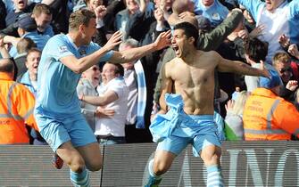 epa03217949 Manchester City's Sergio Aguero (R) and Manchester City's Edin Dzeko (L) celebratre after the winning goal during the English Premier League soccer match at Etihad Stadium Manchester, Britain, 13 May 2012.  EPA/PETER POWELL DataCo terms and conditions apply. http//www.epa.eu/downloads/DataCo-TCs.pdf