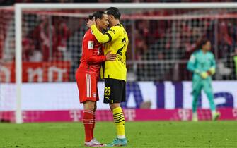 epa10554265 Munich's Leroy Sane (L) and Dortmund's Emre Can (R) react after the German Bundesliga soccer match between FC Bayern Munich and Borussia Dortmund in Munich, Germany, 01 April 2023.  EPA/ANNA SZILAGYI CONDITIONS - ATTENTION: The DFL regulations prohibit any use of photographs as image sequences and/or quasi-video.