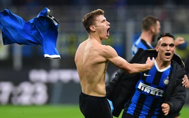 Inter Milan's Italian midfielder Nicolo Barella (C) takes off his jersey as he celebrates with Inter Milan's Argentinian forward Lautaro Martinez (R) after scoring during the Italian Serie A football match Inter Milan vs Hellas Verona on November 9, 2019 at the San Siro stadium in Milan. (Photo by Miguel MEDINA / AFP) (Photo by MIGUEL MEDINA/AFP via Getty Images)