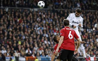 Real Madrid's Portuguese forward Cristiano Ronaldo (top) heads the ball to score during the UEFA Champions League round of 16 first leg football match Real Madrid CF vs Manchester United FC at the Santiago Bernabeu stadium in Madrid on February 13, 2013.  AFP PHOTO / CESAR MANSO        (Photo credit should read CESAR MANSO/AFP via Getty Images)