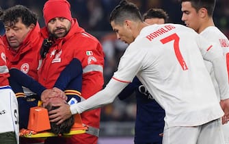 Juventus' Portuguese forward Cristiano Ronaldo (r) tends to AS Roma's Italian midfielder Nicolo Zaniolo as he is stretched out of the pitch after being injured during the Italian Serie A football match AS Roma vs Juventus on January 12, 2020 at the Olympic stadium in Rome. (Photo by Andreas SOLARO / AFP) (Photo by ANDREAS SOLARO/AFP via Getty Images)