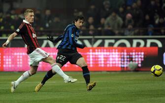 Inter Milan's Argentinian forward Diego Milito (R) evades a tackle by A.C. Milan's midfielder Ignazio Abate and shoots at goal during their Serie A football match Inter Milan vs AC Milan at the San Siro Stadium in Milan on  January 24, 2010. AFP PHOTO / GIUSEPPE CACACE (Photo credit should read GIUSEPPE CACACE/AFP via Getty Images)