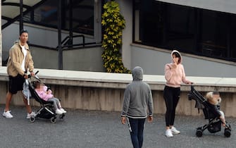 Cristiano Ronaldo (L) and his partner Georgina Rodriguez push two strollers as they have a walk with their children in Funchal on March 28, 2020. (Photo by HELDER SANTOS / AFP) (Photo by HELDER SANTOS/AFP via Getty Images)