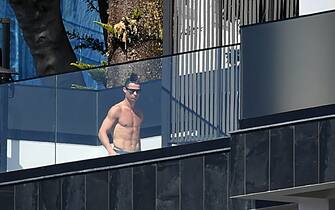 Portugal and Juventus' Portuguese forward Cristiano Ronaldo sunbathes at his home in Funchal on March 16, 2020. - Ronaldo has been in quarantine in Madeira for several days but is not showing any symptoms of the coronavirus contracted by a Juventus teammate, local authorities in Portugal said. (Photo by RUI SILVA / AFP) / The erroneous date appearing in the metadata of this photo by RUI SILVA has been modified in AFP systems in the following manner: [on March 16, 2020] instead of [on March 17, 2020]. Please immediately remove the erroneous mention[s] from all your online services and delete it (them) from your servers. If you have been authorized by AFP to distribute it (them) to third parties, please ensure that the same actions are carried out by them. Failure to promptly comply with these instructions will entail liability on your part for any continued or post notification usage. Therefore we thank you very much for all your attention and prompt action. We are sorry for the inconvenience this notification may cause and remain at your disposal for any further information you may require. (Photo by RUI SILVA/AFP via Getty Images)